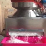 Coconut grinding machine is at work.