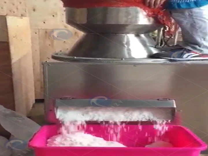 Coconut grinding machine is at work.